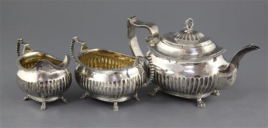 A George III demi fluted silver three piece oval tea set, gross 37.5 oz.